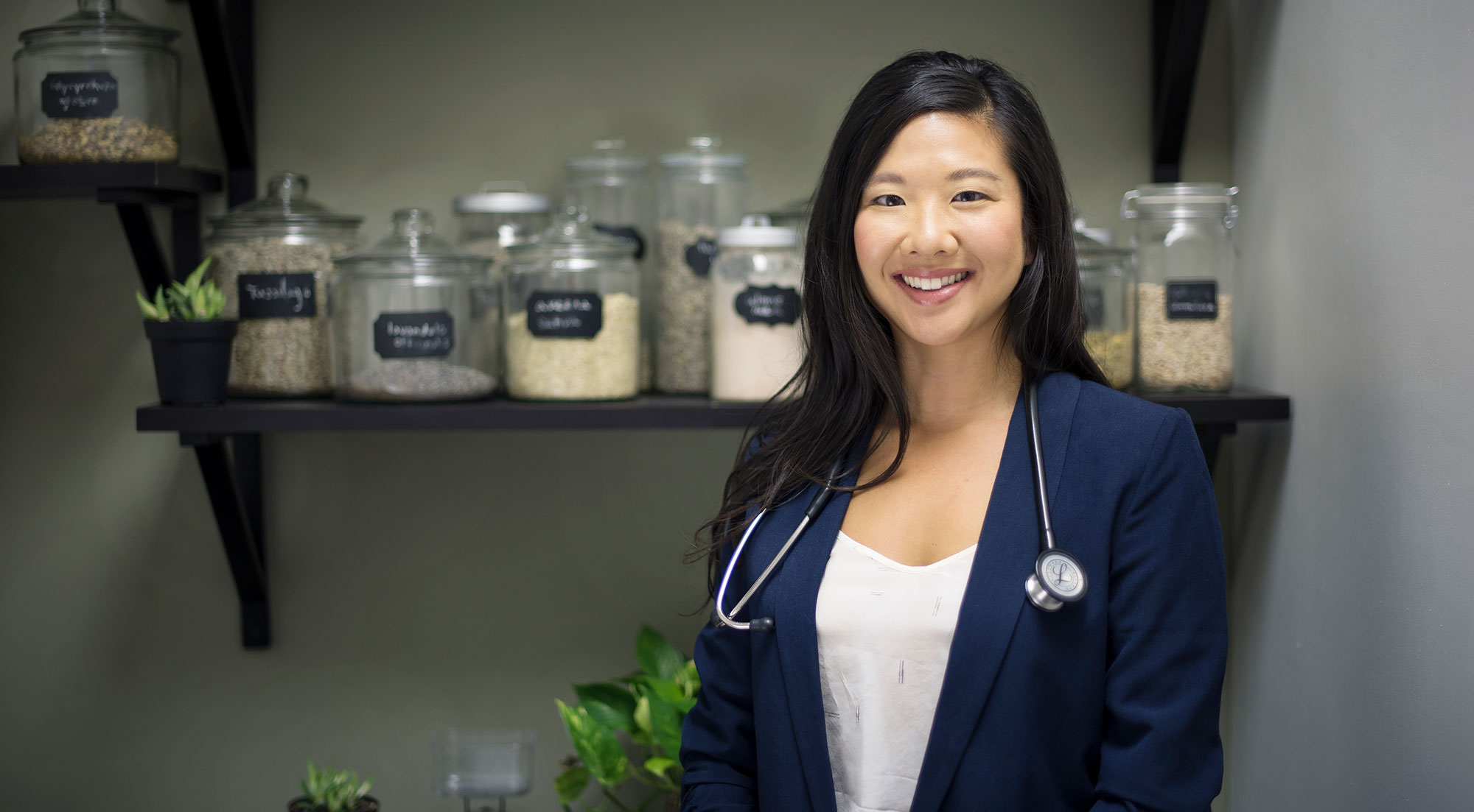 Dr. Tanya Lee with jar of herbs in the background
